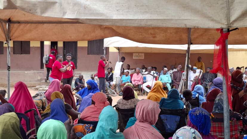 Deaf women holding advocacy placards